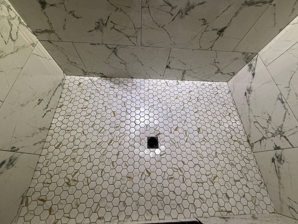 Hexagon tile shower floor being installed