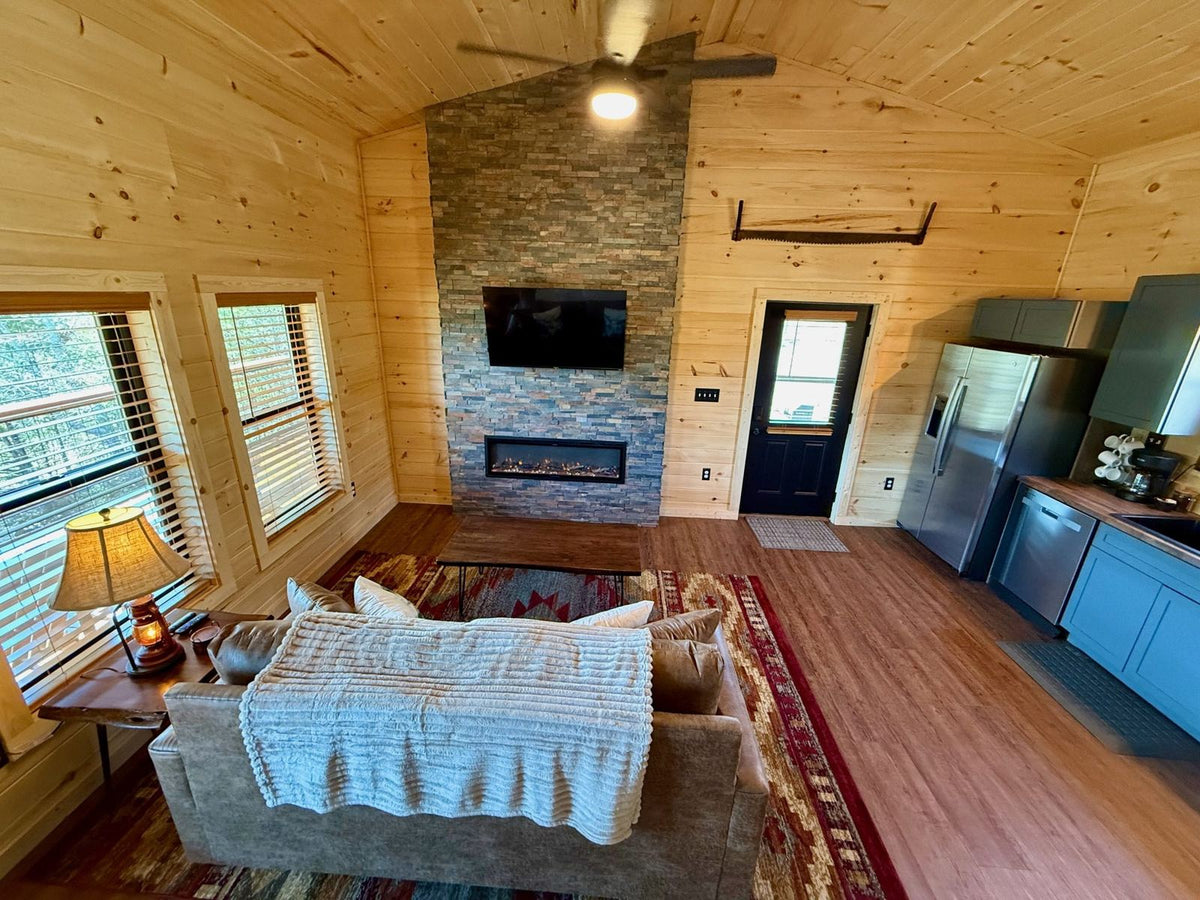 Living room with stone fireplace wall